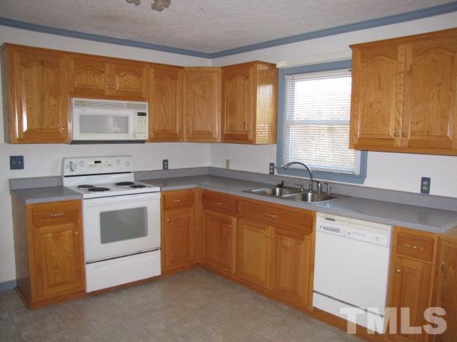 1857 Red Marshall Road Pelham, NC 27311 - Photo 5 of 18 a kitchen with granite countertop white cabinets sink and window