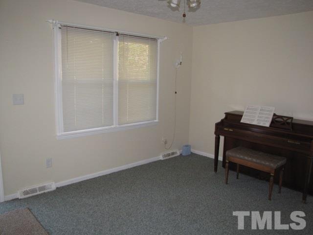 1857 Red Marshall Road Pelham, NC 27311 - Photo 7 of 18 a room that has a dresser and a chair