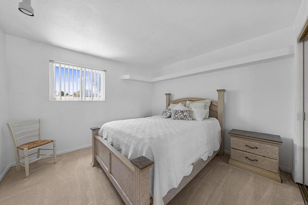 30265 Miller Road Valley Center, CA 92082 - Photo 25 of 56 a bedroom with bed and a window