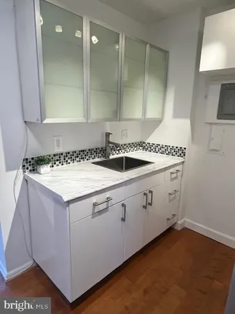 a utility room with a sink washer and dryer