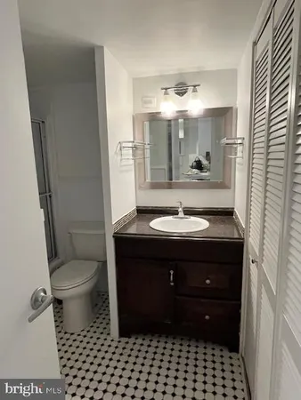 a bathroom with a sink vanity and a toilet