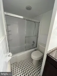 a bathroom with a shower a toilet and a shower