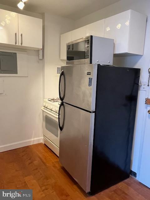 922 24th Street Northwest, Unit 718 Washington, DC 20037 - Photo 10 of 28 a view of kitchen with stainless steel appliances wooden floor and staircase