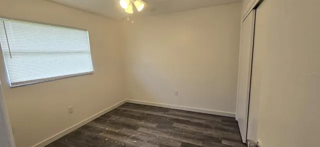 a view of a small space with wooden floor and a window