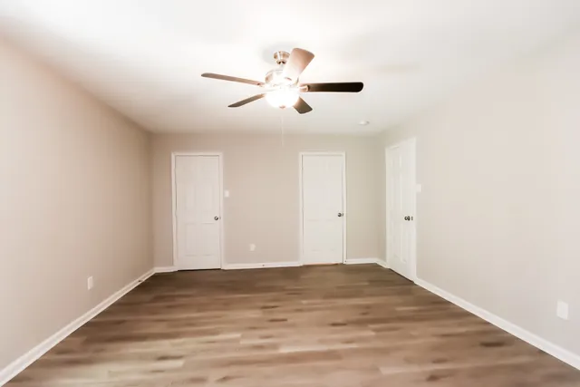 a view of a room with wooden floor