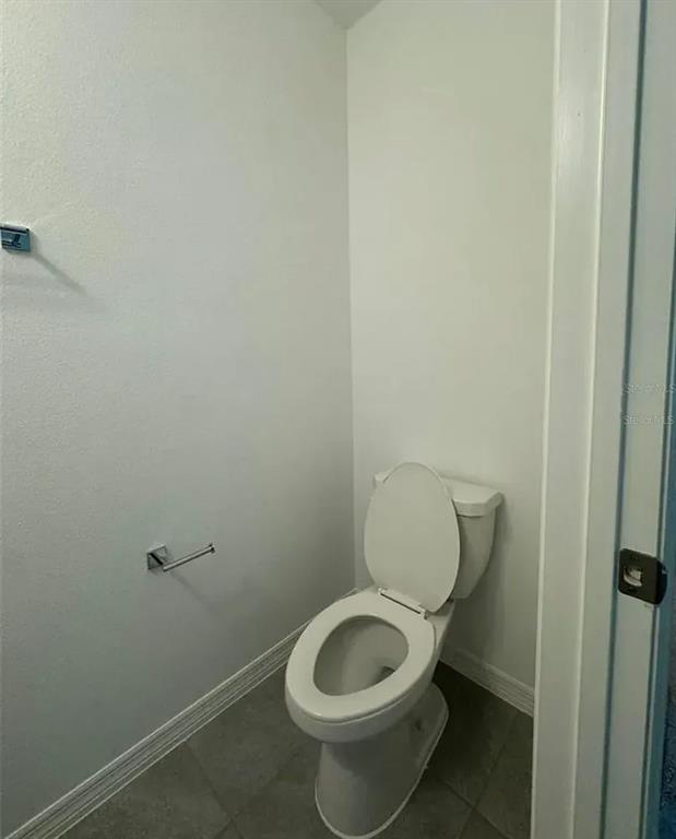 15074 Windflower Alley Winter Garden, FL 34787 - Photo 14 of 18 a white toilet sitting next to a shower