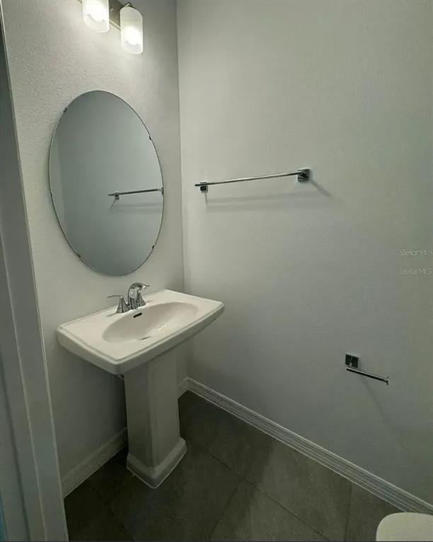 15074 Windflower Alley Winter Garden, FL 34787 - Photo 15 of 18 a bathroom with a sink toilet and mirror