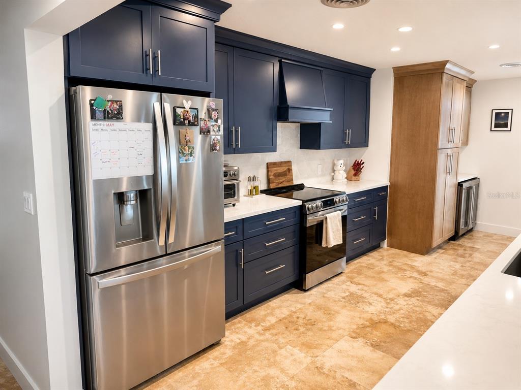 5431 Foley Square New Port Richey, FL 34652 - Photo 11 of 39 a kitchen with stainless steel appliances granite countertop a refrigerator a stove and a sink