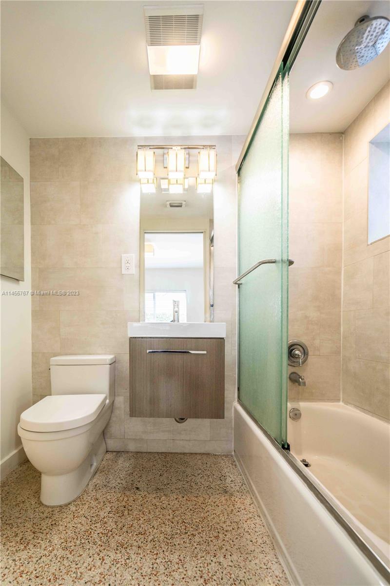666 Northeast 80th Street, Unit 5 Miami, FL 33138 - Photo 11 of 19 a bathroom with a toilet a sink and bathtub