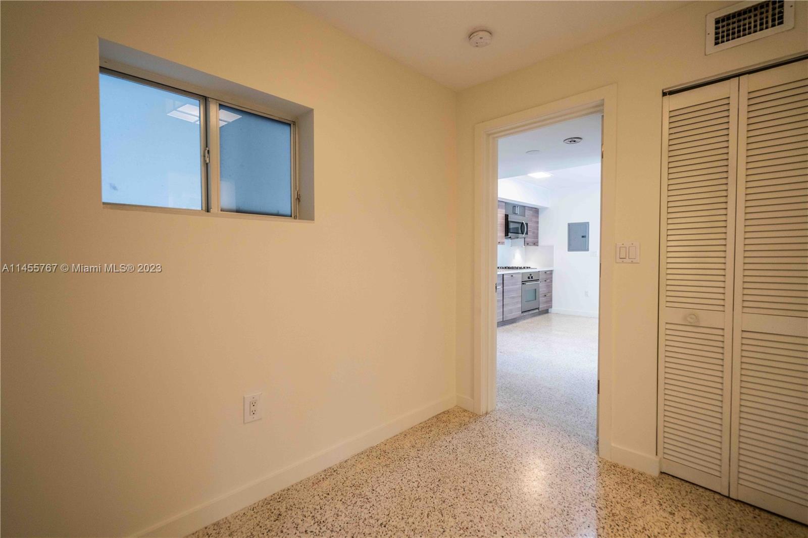 666 Northeast 80th Street, Unit 5 Miami, FL 33138 - Photo 15 of 19 a view of a hallway with wooden shelves