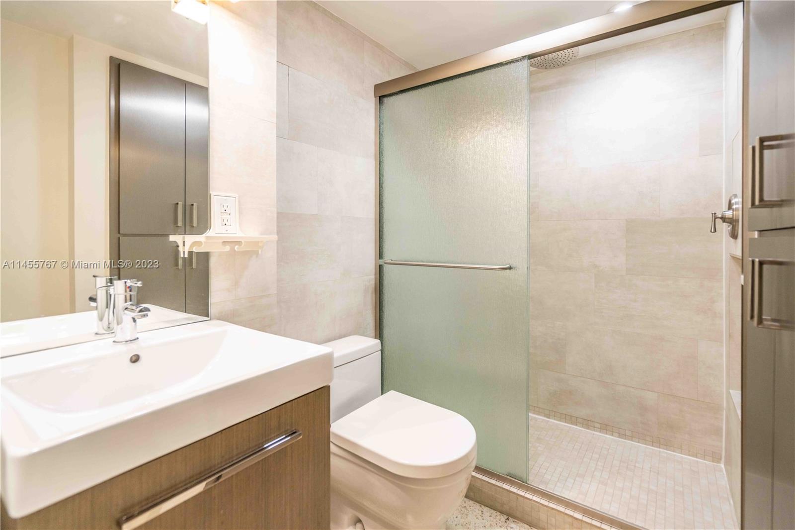 666 Northeast 80th Street, Unit 5 Miami, FL 33138 - Photo 16 of 19 a bathroom with a sink toilet and shower