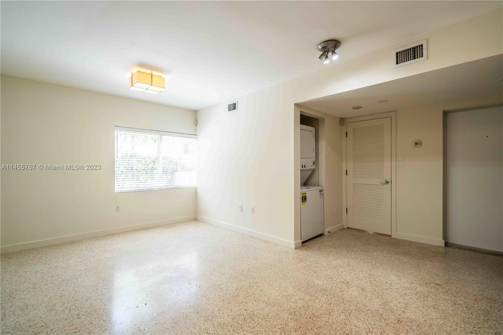 666 Northeast 80th Street, Unit 5 Miami, FL 33138 - Photo 4 of 19 an empty room with windows