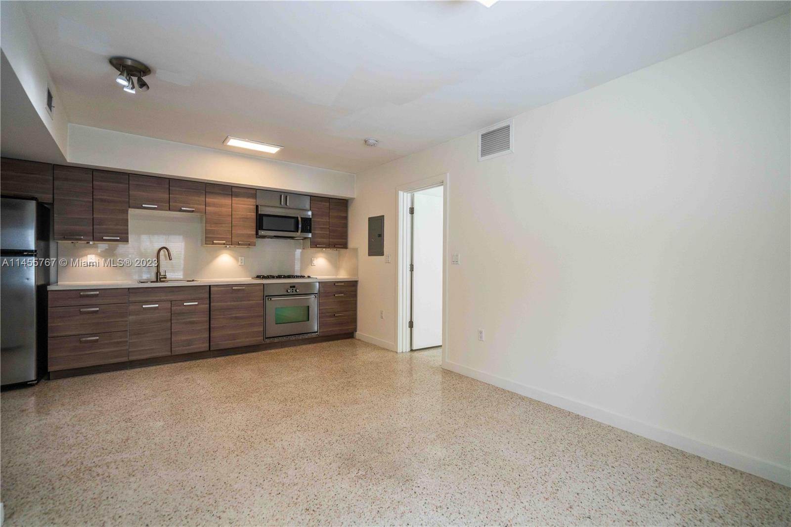 666 Northeast 80th Street, Unit 5 Miami, FL 33138 - Photo 6 of 19 a view of a kitchen with refrigerator and a sink