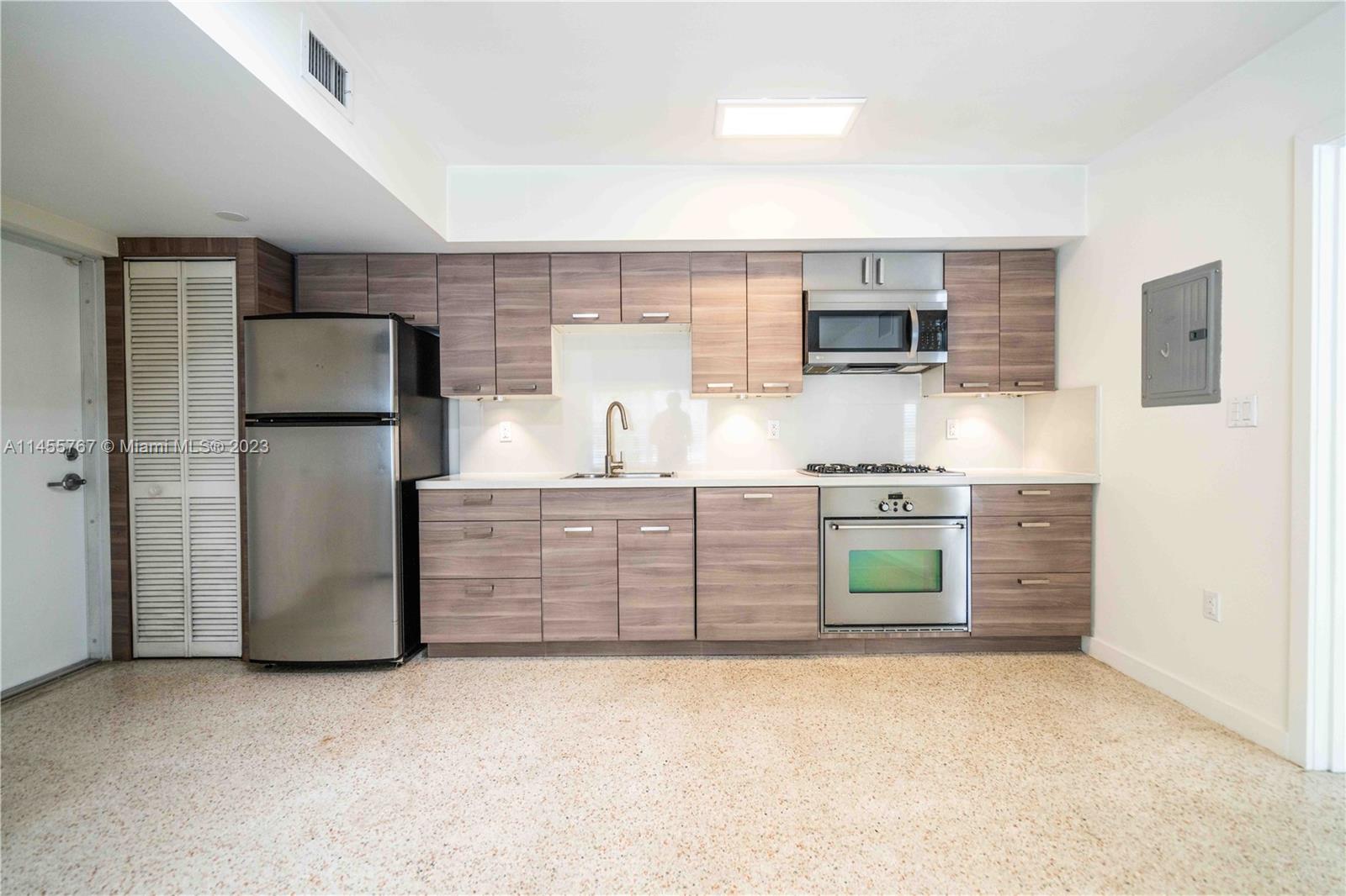 666 Northeast 80th Street, Unit 5 Miami, FL 33138 - Photo 7 of 19 a kitchen with stainless steel appliances a refrigerator sink and stove