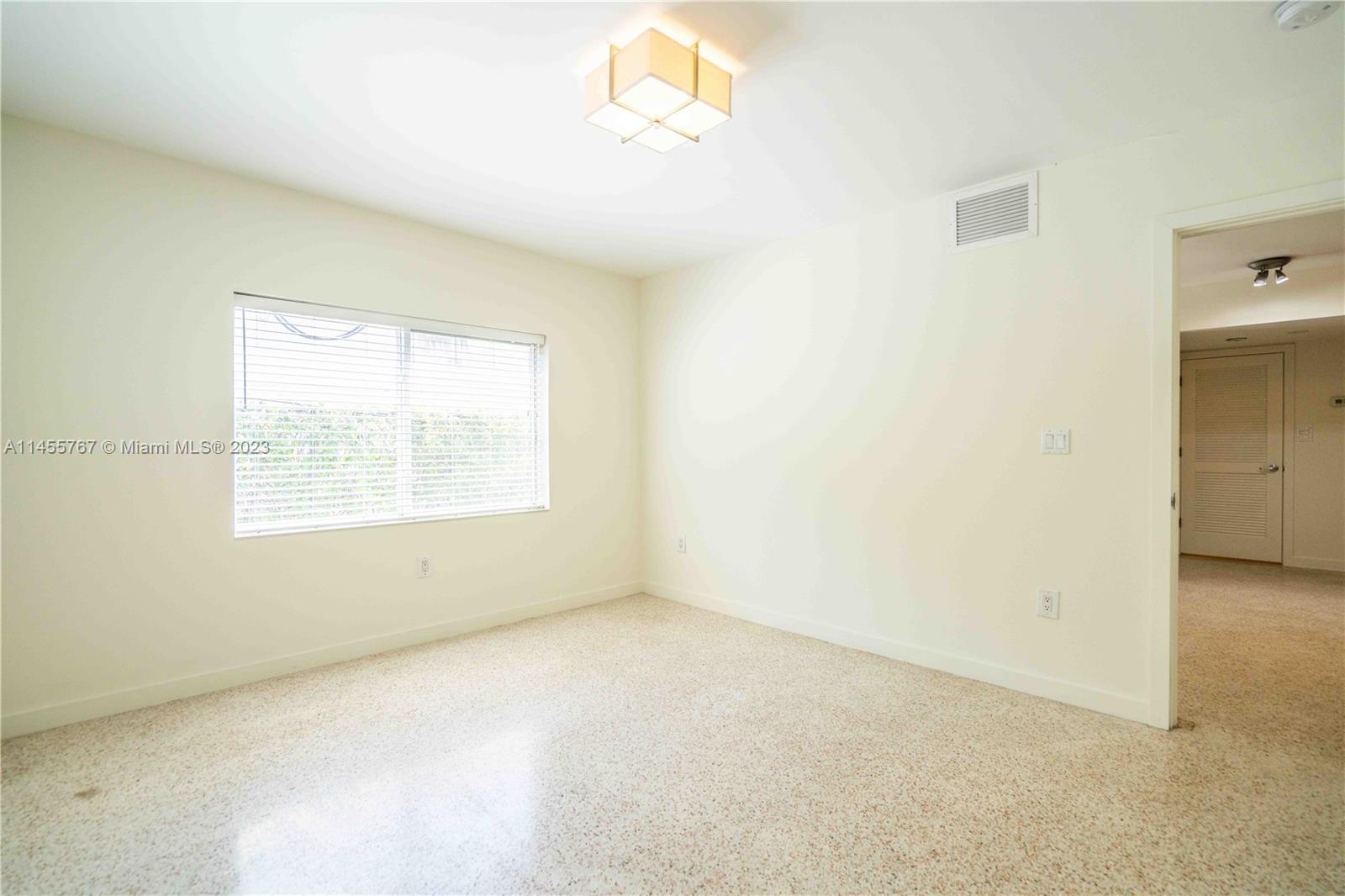 666 Northeast 80th Street, Unit 5 Miami, FL 33138 - Photo 9 of 19 an empty room with a window
