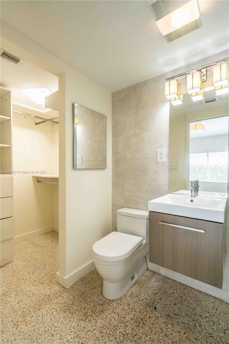 666 Northeast 80th Street, Unit 5 Miami, FL 33138 - Photo 10 of 19 a bathroom with a sink a toilet and a mirror