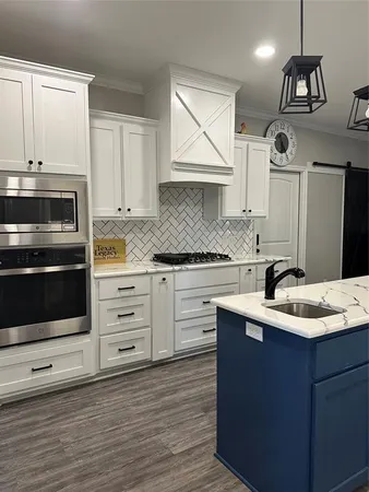 a kitchen with a sink stove and cabinets