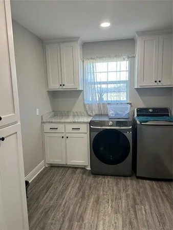 a kitchen with a stove a sink and a microwave