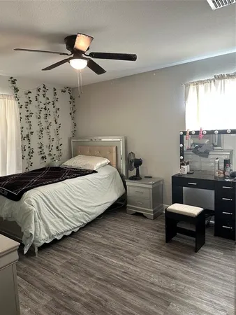 a bedroom with furniture and a large window