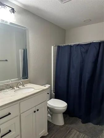 a bathroom with a toilet a sink and a mirror