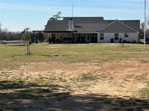 a white house with a large pool
