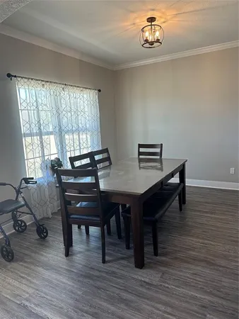 a view of a workspace with furniture and wooden floor