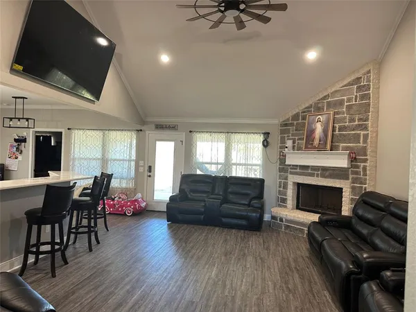 a living room with furniture fireplace and flat screen tv