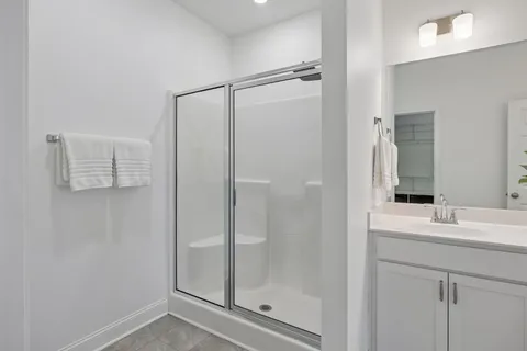 a bathroom with a shower sink and mirror