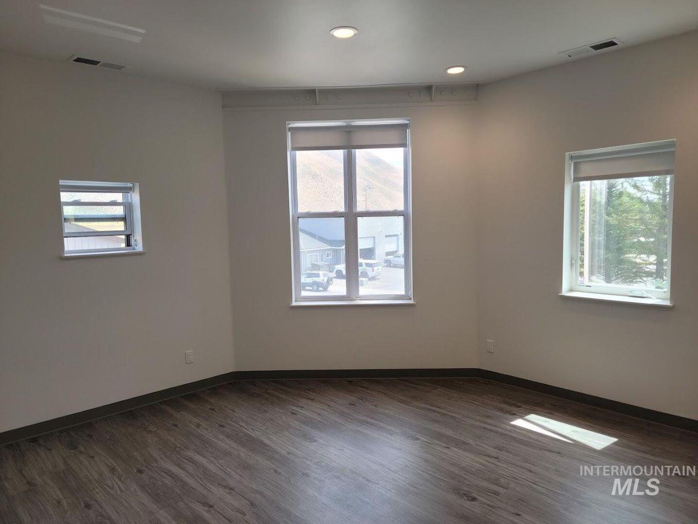 121 Honeysuckle Street Bellevue, ID 83313 - Photo 5 of 13 Spare room featuring dark wood finished floors and recessed lighting