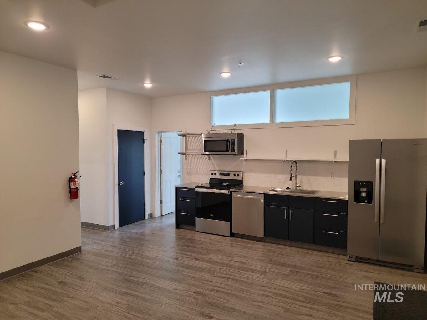 121 Honeysuckle Street Bellevue, ID 83313 - Photo 6 of 13 Kitchen with stainless steel appliances, dark cabinets, light countertops, dark wood-type flooring, and recessed lighting