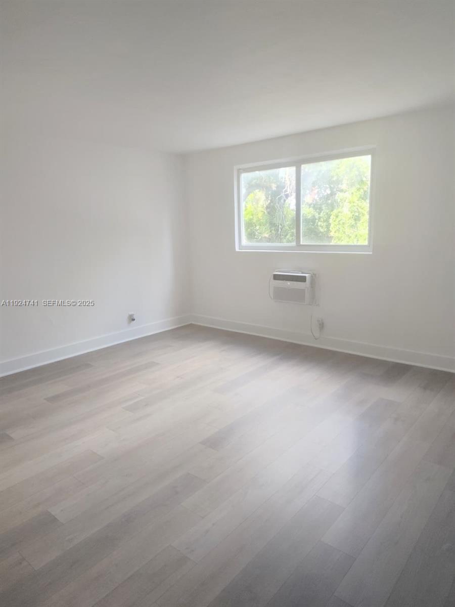 143 Southwest 9th Street, Unit 203 Miami, FL 33130 - Photo 2 of 9 an empty room with a window