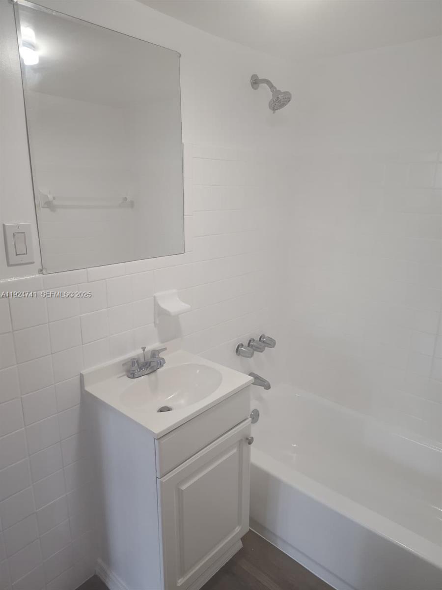 143 Southwest 9th Street, Unit 203 Miami, FL 33130 - Photo 5 of 9 a bathroom with a sink and a bathtub
