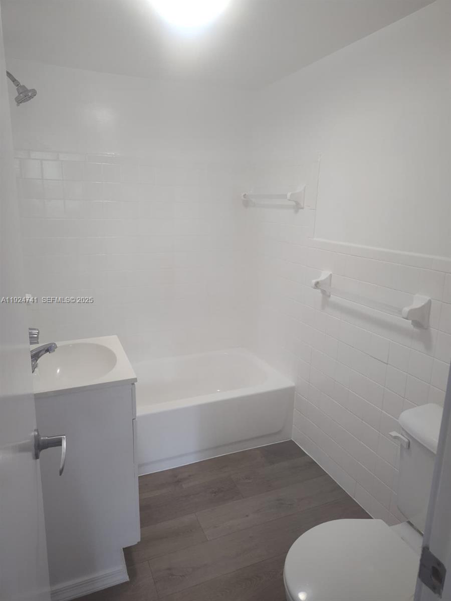 143 Southwest 9th Street, Unit 203 Miami, FL 33130 - Photo 6 of 9 a bathroom with a sink a toilet and bathtub