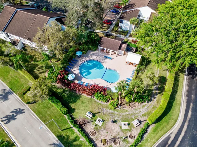 an aerial view of residential houses with outdoor space