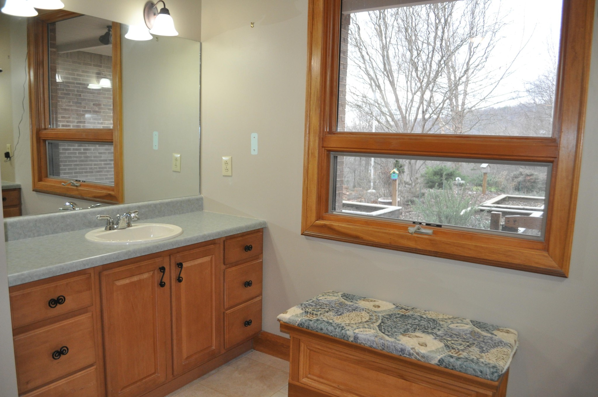400 Burkhart Road Rutledge, TN 37861 - Photo 27 of 33 a bathroom with a granite countertop sink and a large mirror next to a window