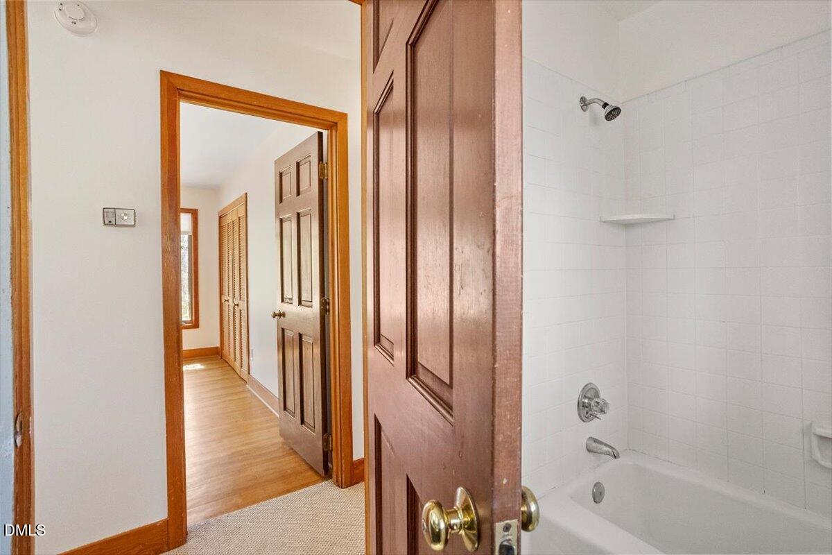 4805 Rembert Drive Raleigh, NC 27612 - Photo 22 of 45 a bathroom with a bathtub and a shower
