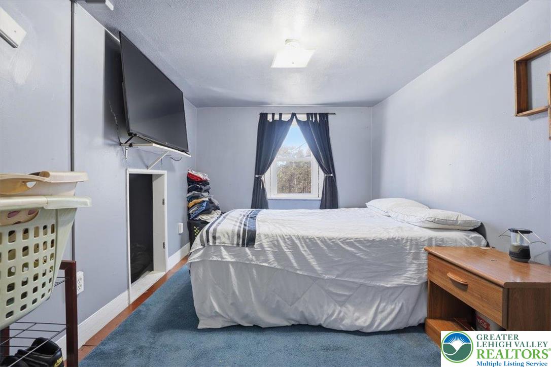 4532 Long Run Road Lehighton, PA 18235 - Photo 32 of 84 a bedroom with a bed and a flat tv screen on dresser