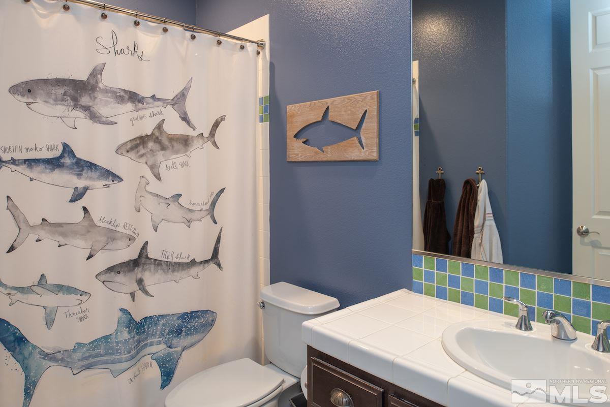 9898 Kerrydale Court Reno, NV 89521 - Photo 17 of 25 a bathroom with a sink toilet and mirror