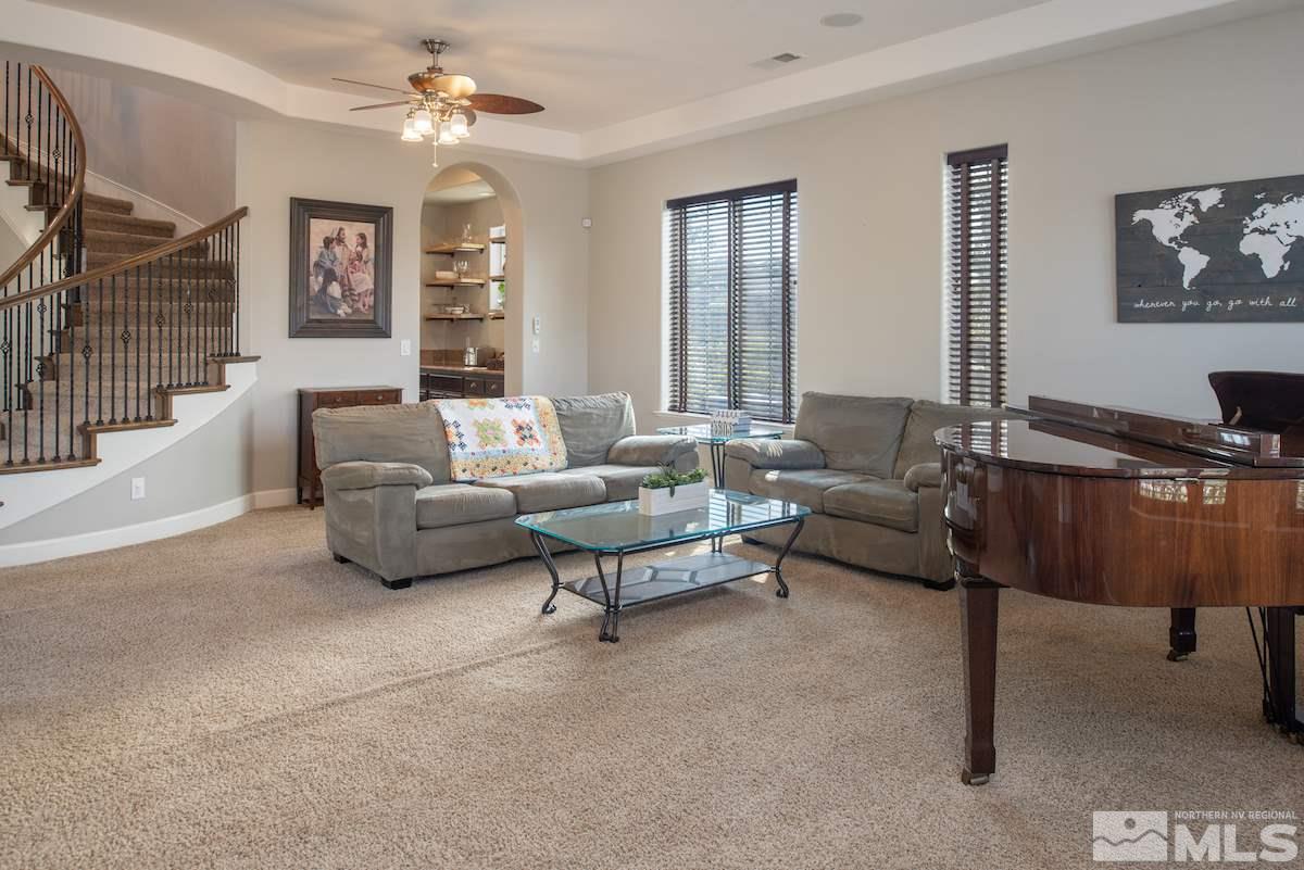 9898 Kerrydale Court Reno, NV 89521 - Photo 5 of 25 a living room with furniture ceiling fan and a window