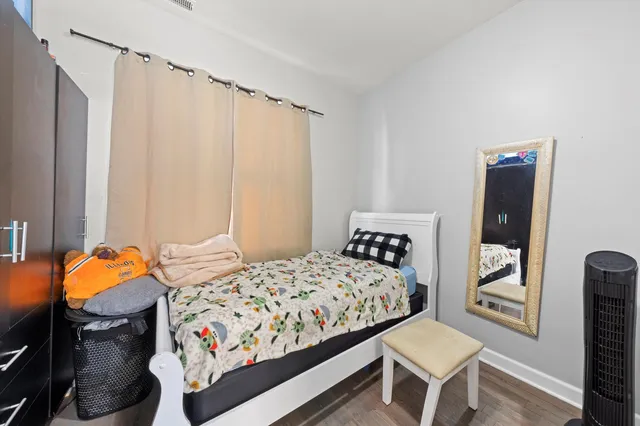 a bedroom with a bed and a chair in it