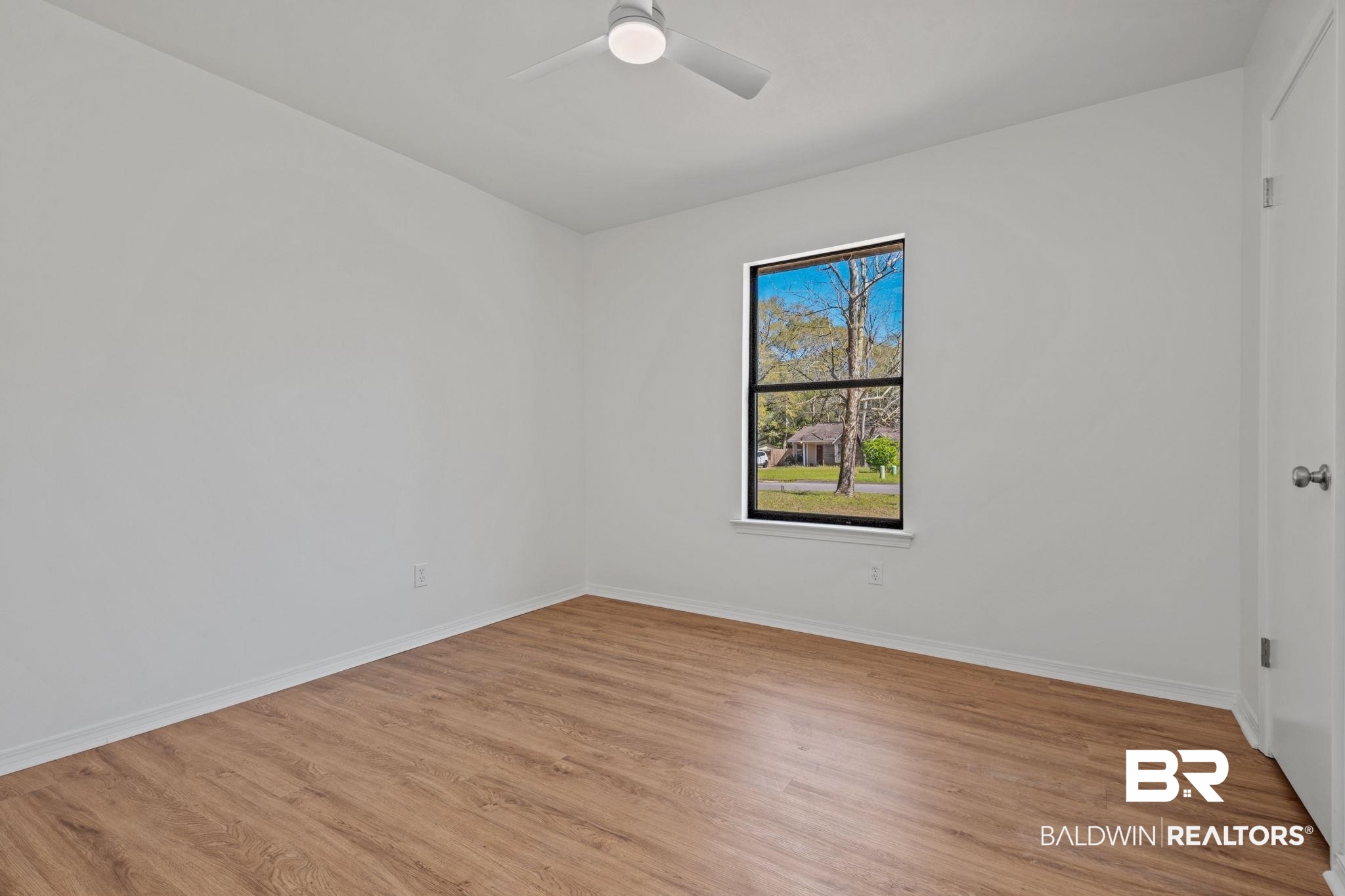5734 Pheasant Court Theodore, AL 36582 - Photo 12 of 23 Empty room featuring light wood-style floors and a ceiling fan