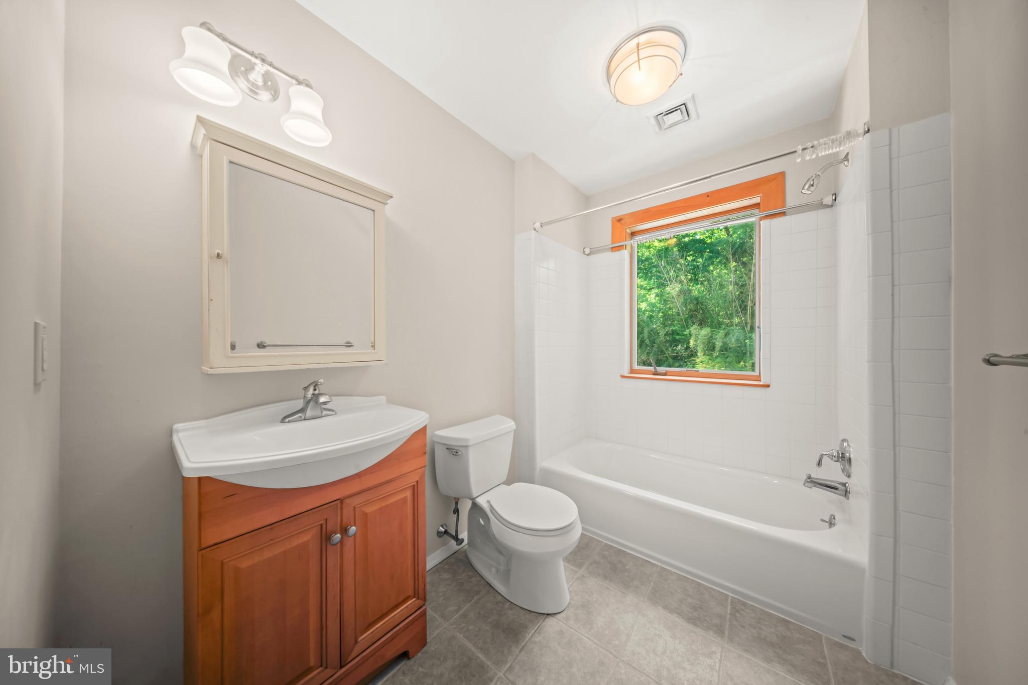 1473 North River Road Yardley, PA 19067 - Photo 36 of 42 a bathroom with a toilet a sink a tub and mirror