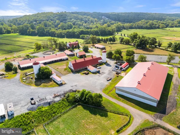 an aerial view of a house with a garden and lake view