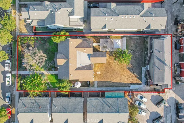 an aerial view of a residential apartment building with a yard