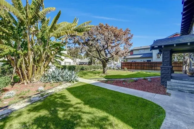 a kitchen with granite countertop a stove a sink and a microwave
