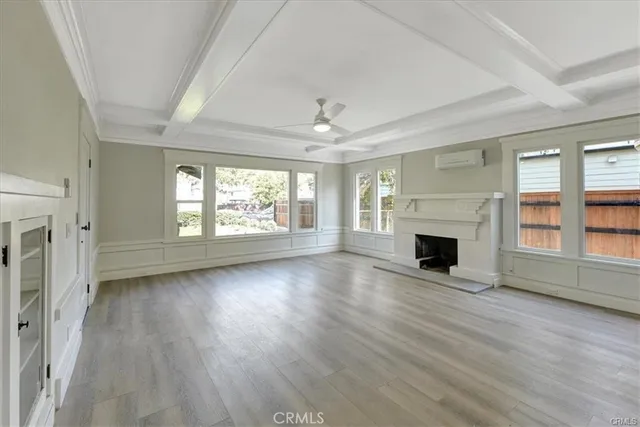 a view of kitchen with stainless steel appliances refrigerator oven and white cabinets with wooden floor
