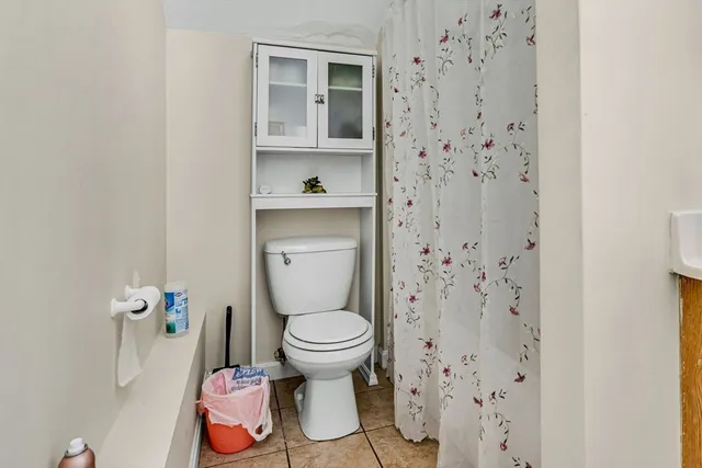 a white toilet sitting next to a bathroom sink