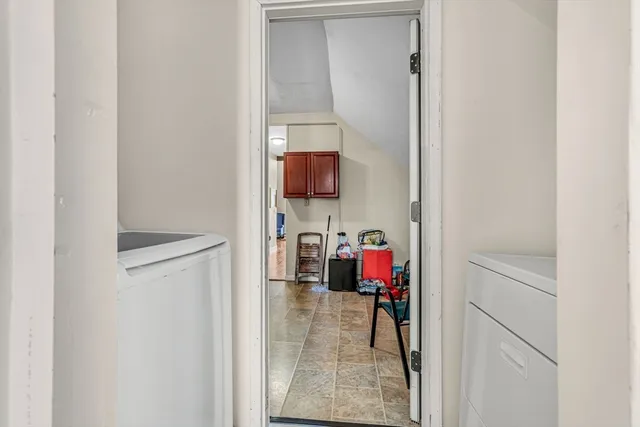 a view of walk in closet with clothes
