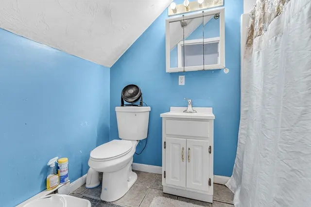 a white toilet sitting next to a bathroom sink