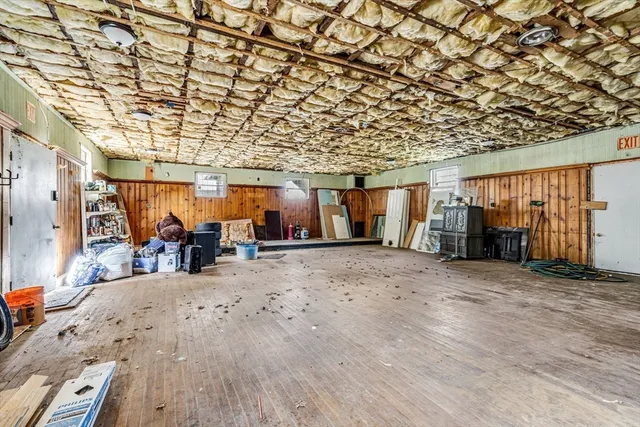 a view of a parking space with wooden walls